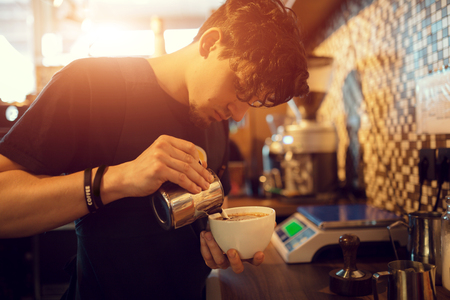 Barista at work in a coffee shop. Preparation service conceptの写真素材