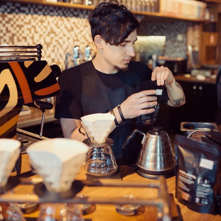 Barista at work in a coffee shop. Preparation service conceptの写真素材