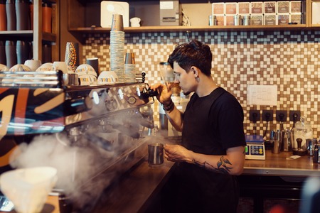 Barista at work in a coffee shop. Preparation service conceptの写真素材