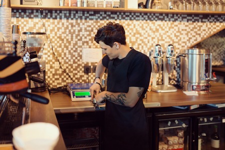 Barista at work in a coffee shop. Preparation service conceptの写真素材