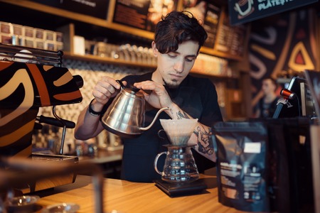 Barista at work in a coffee shop. Preparation service conceptの写真素材
