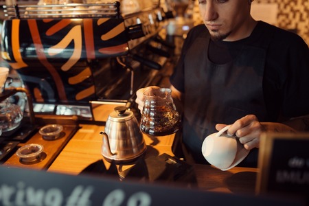 Barista at work in a coffee shop. Preparation service conceptの写真素材