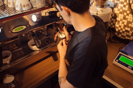 Barista at work in a coffee shop. Preparation service conceptの写真素材