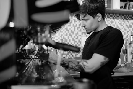 Barista at work in a coffee shop. Preparation service conceptの写真素材