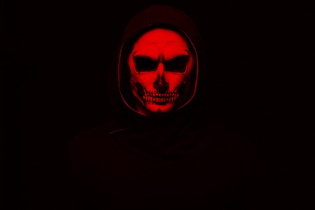 Portrait man with Halloween skull makeup. Halloween or horror theme. Red filterの写真素材