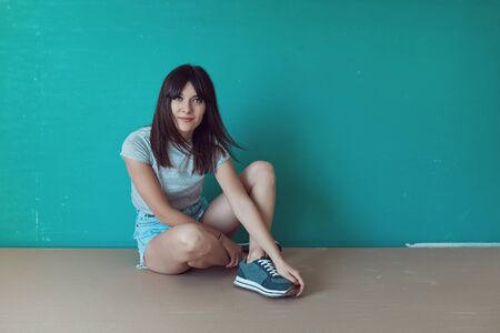 Portrait of pretty brunette woman posing in an unfinished indoor.の写真素材