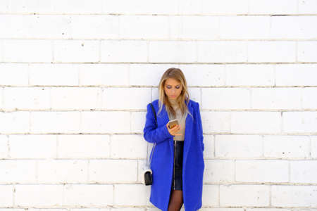 Portrait of the girl in the blue coat on the street, stylish outfit, woman fashion, street shootingの写真素材