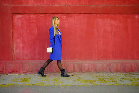 Portrait of the girl in the blue coat on the street, stylish outfit, woman fashion, street shootingの写真素材