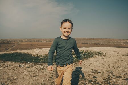 Little young caucasian boy in nature, childhood in image with copy space
