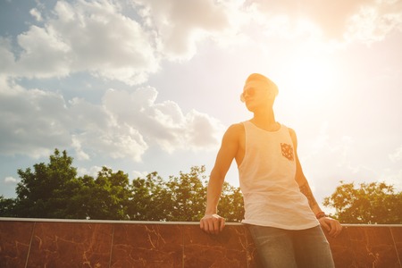 Hipster handsome man guy in stylish summer clothes in the street in sunglassesの写真素材