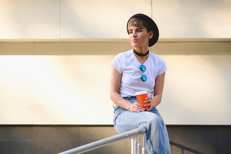 Close up portrait of female hipster with natural makeup and short haircut enjoying leisure time outdoorsの写真素材