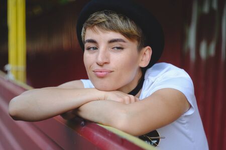 Close up portrait of female hipster with natural makeup and short haircut enjoying leisure time outdoorsの写真素材