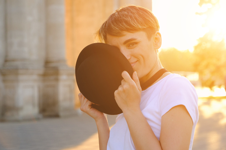 Close up portrait of female hipster with natural makeup and short haircut enjoying leisure time outdoorsの写真素材