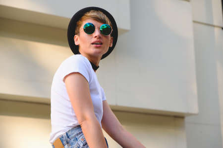 Close up portrait of female hipster with natural makeup and short haircut enjoying leisure time outdoorsの写真素材