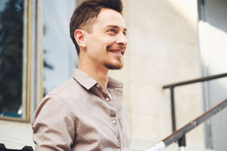 Handsome man outdoors portrait in the city. Warm colors