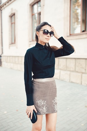 Beautiful brunette young woman walking through the streets of Old City. Fashion conceptの写真素材