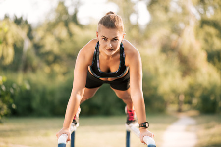 Workout Exercise. Close-up Of Healthy Handsome Active Woman With Fit Muscular Body Doing Push Ups Exercises. Sporty Athletic Female Doing Plank At Park, Training Outdoor. Sports And Fitness Conceptの写真素材