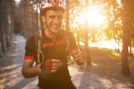 Young man are cycling road bike by the lake in the parkの写真素材