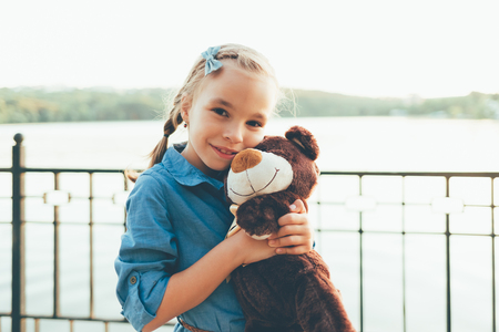 Girl embracing a cute teddy bearの写真素材