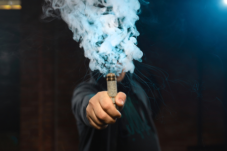 Dripper in one hand making a cloud of fumeの写真素材