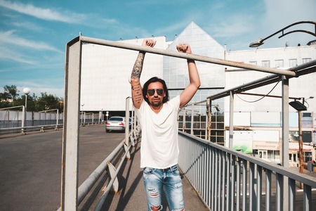 Attractive man with sunglasses hanging out in the cityの写真素材