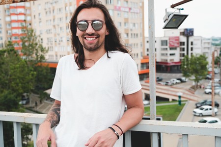 Smiling man in sunglasses enjoying lifeの写真素材