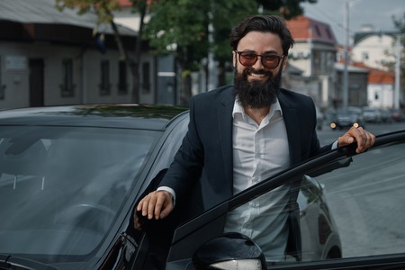 Portrait stylish, handsome man near car outdoorsの写真素材