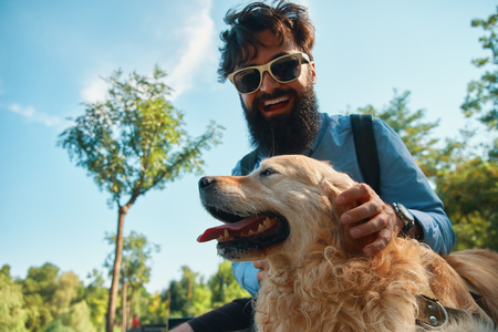 Man and dog having fun, playing, making funny faces while restinの写真素材