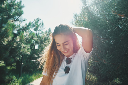 Close-up young woman with beautiful face features enjoying sunの写真素材