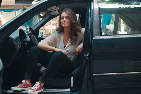 Woman getting out of a car.