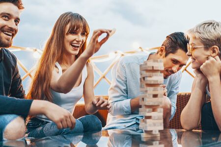 The company of young people playing wooden blocksの写真素材