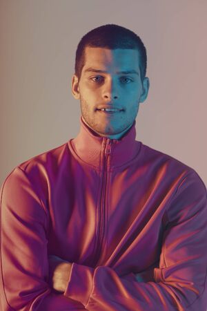 Close-up portrait of attractive male model. Retro wave portrait of a young man at studio. High...