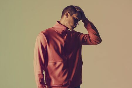 Close-up portrait of attractive male model. Retro wave portrait of a young man at studio. High Fashion male model in colorful bright neon lights. Art design conceptの写真素材