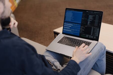 Man working on computer. Young it worker using laptop in the office, Internet marketing, technology,...