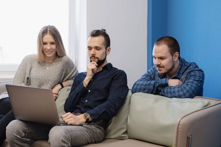 Small soft meeting area in chill out zone of office with three persons having there work meeting or...