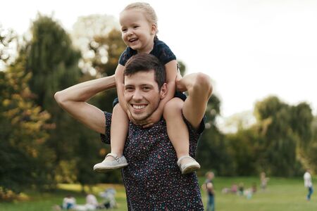 Happy dad and child spending time outdoors. Father daughter moments.の写真素材
