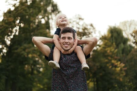Happy dad and child spending time outdoors. Father daughter moments.の写真素材