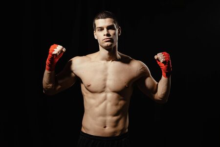 Boxer power pose holding hands up with naked torso. beautiful torso relief. Winner concept.の写真素材