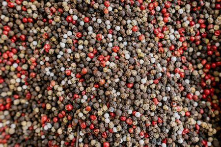 Background mix of white, black, red peppercorns. Aromatic pepper spice