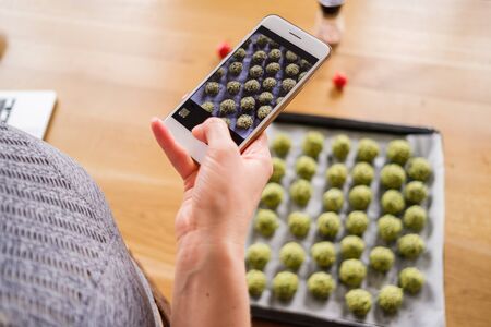 Smartphone food photography of vegetarian food. Woman hands taking phone photo of food in trendy...
