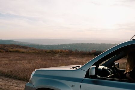 Driving a gray car under blue sky. Interior Tourism, driving by car. Discover small countries.