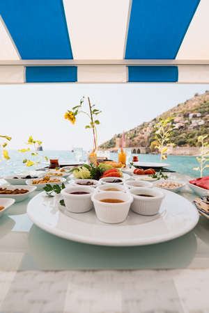 Fresh breakfast in a beautiful location with sea viewsの写真素材