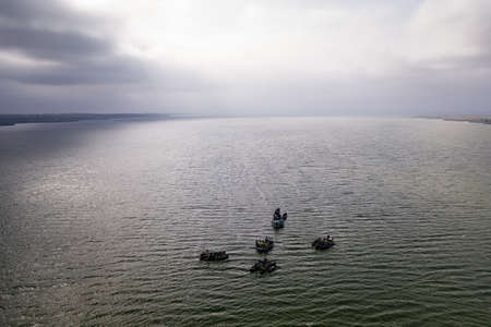 Fishing boats, floating the calm waters and going for fishing under a sky with cloudsの写真素材