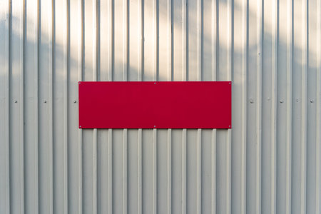 White iron tin fence lined background. Metal texture with red rectangle for textの写真素材