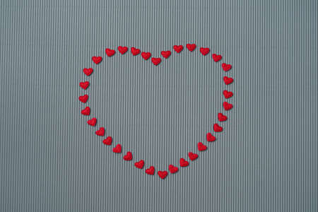 Paper elements in shape of heart on gray background. Symbol of love for Happy Womens, Mothers,...