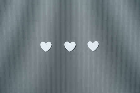 Paper elements in shape of white, hearts on gray background. Symbol of love for Happy Womens,...