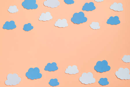 Elements in shape of clouds surrounding orange background with space for text on orange background. Mockup, copy spaceの写真素材