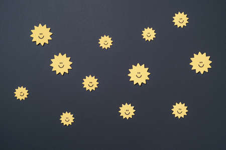 Elements in shape of yellow stars and smiling moon on paper black background. Greeting card design. Flat lay. Top viewの写真素材