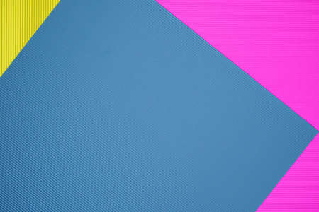 Blue, pink and yellow three tone color paper background with stripes. Abstract background modern hipster futuristic. Texture designの写真素材