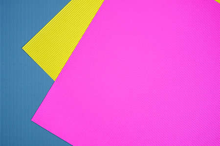 Blue, pink and yellow three tone color paper background with stripes. Abstract background modern hipster futuristic. Texture designの写真素材